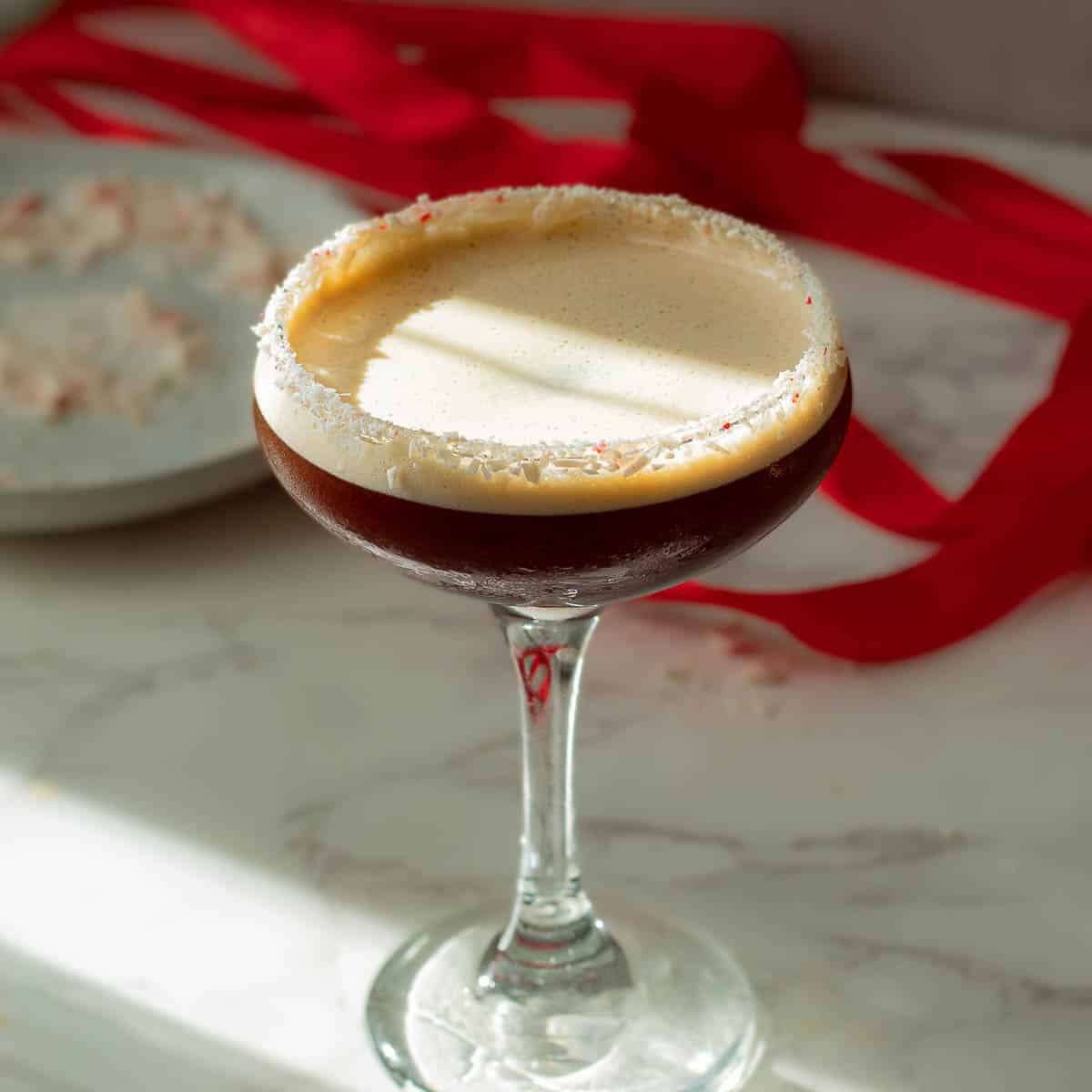 Blend frozen coffee, peppermint liqueur, vodka, and simple syrup until smooth and creamy