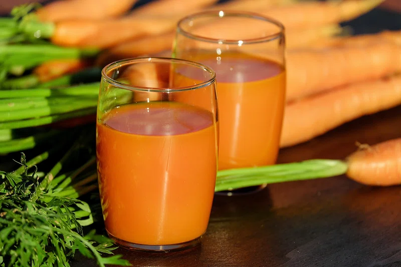 Gather carrots, apples, liquid, and optional sweetness and spice