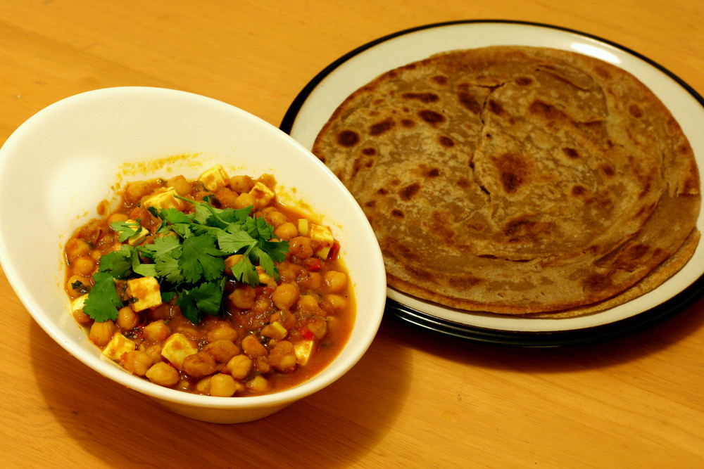 Chana masala, a flavorful chickpea stew popular in India and Pakistan, is easy to make with simple ingredients and versatile serving options