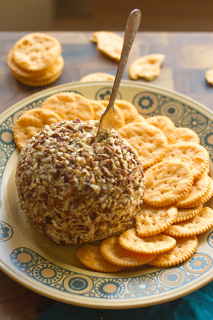 Gather unsalted cashews, Dijon mustard, nutritional yeast, coconut oil, maple syrup, salt, and optional pecans to create this vegan cheese ball