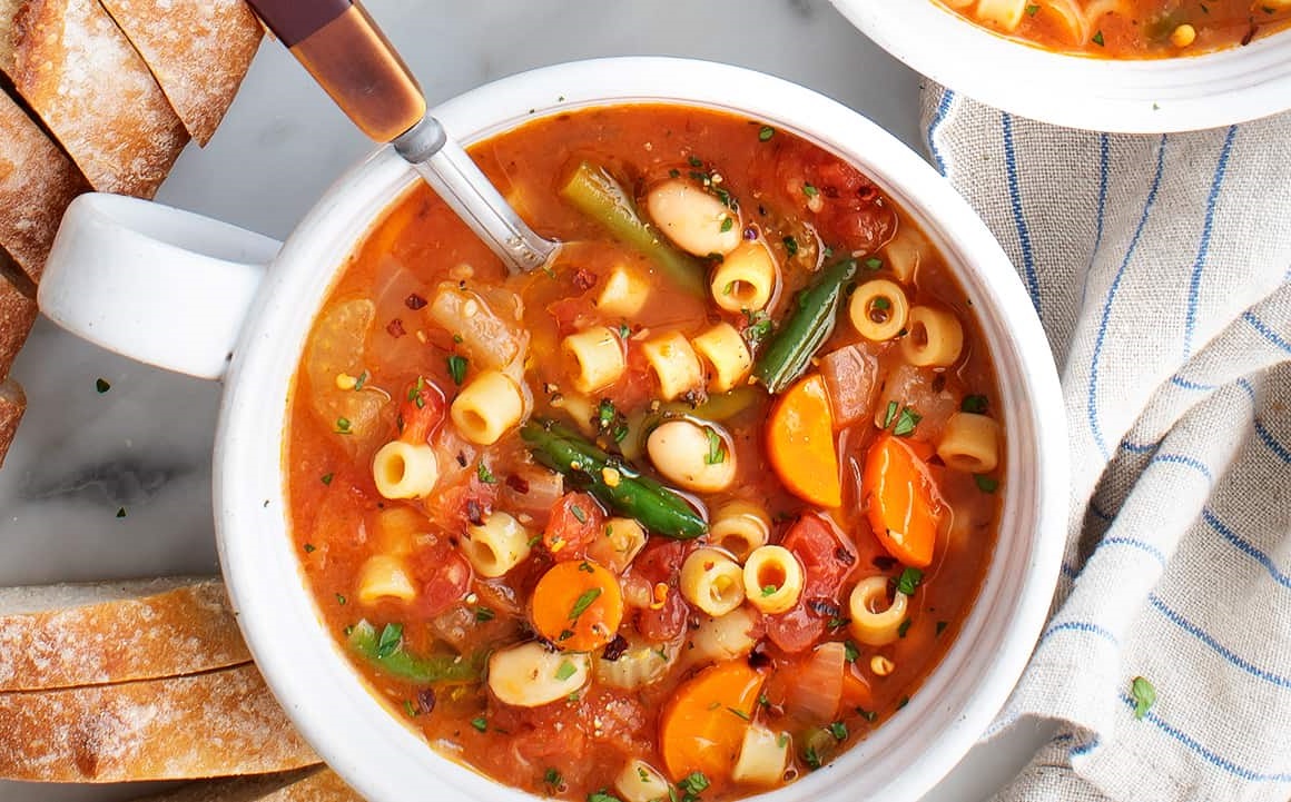 Minestrone, a flavorful Italian tradition, is a hearty, veggie-packed soup bursting with seasonal flavors