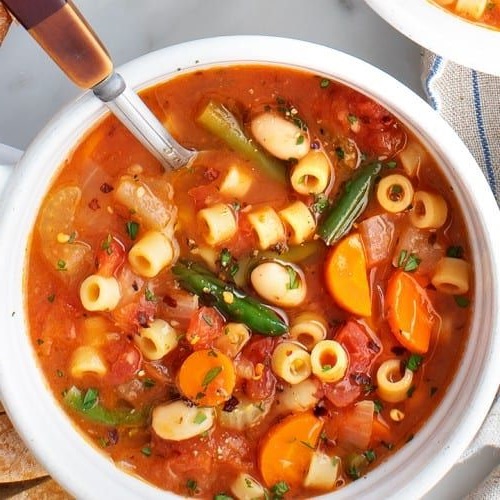 Olive oil, vegetables, tomatoes, beans, broth, herbs, pasta, lemon, and Parmesan create a vibrant minestrone