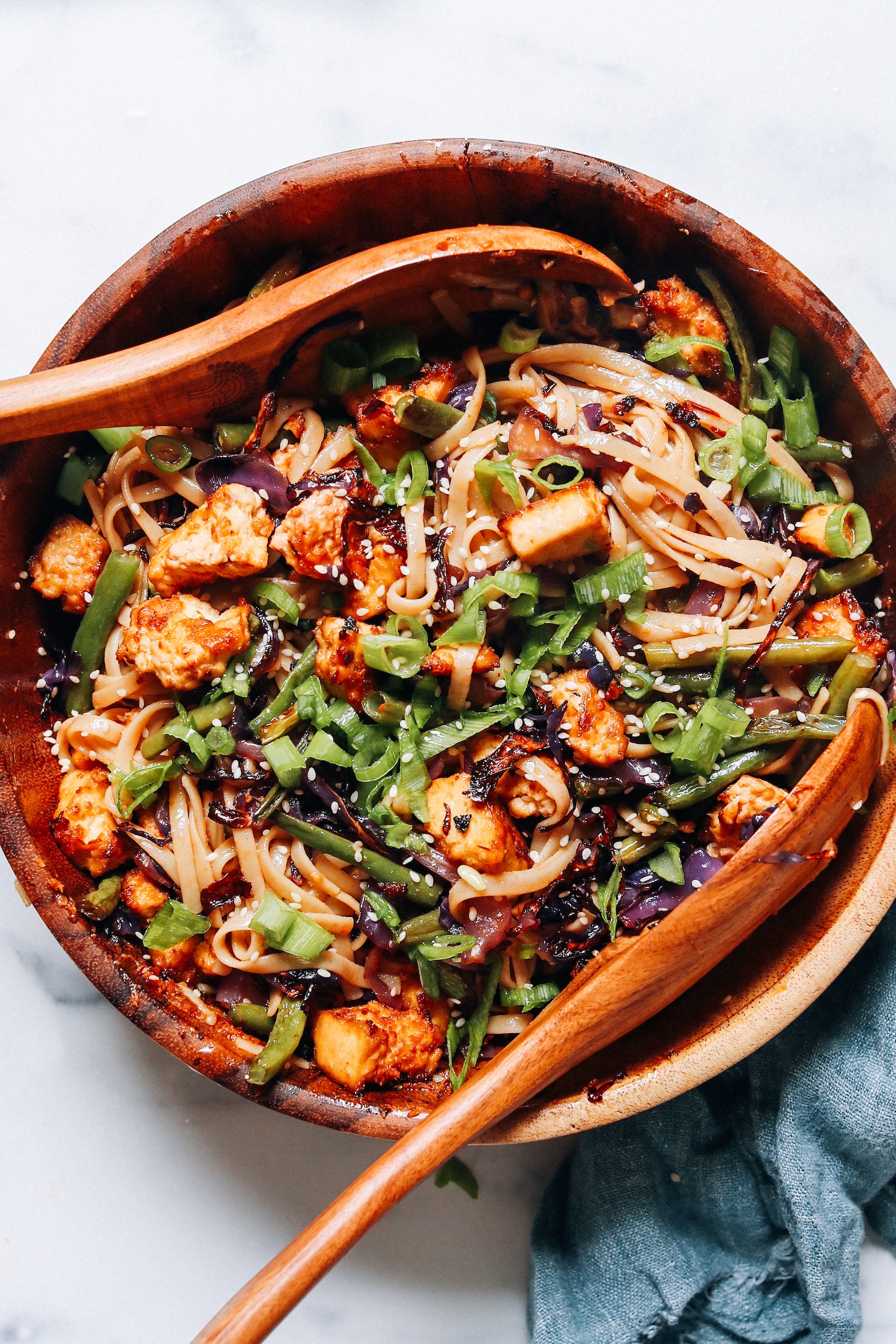 Savor a vibrant symphony of flavors and textures with this vegan stir-fry, brimming with sesame noodles, fresh veggies, and tofu