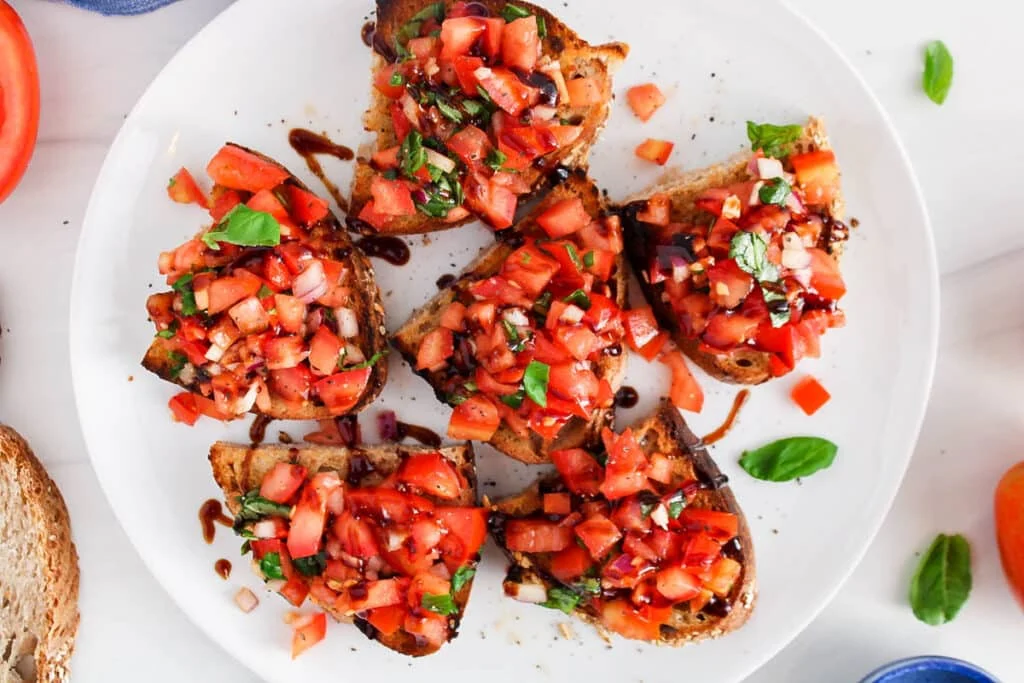 Toast bread, mix toppings, assemble, and enjoy your vegan bruschetta!