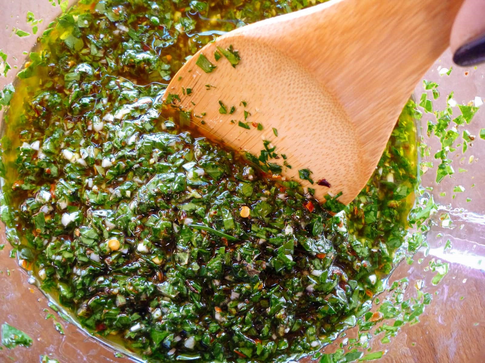 While the eggplant roasts, chop or pulse fresh herbs, garlic, and spices to make a vibrant chimichurri